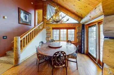 a dining room with a table and chairs in a cabin at Fairy Tale House in Dillon