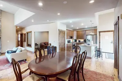 a kitchen and living room with a wooden table and chairs at Bears Den Condo Unit 1 in Frisco