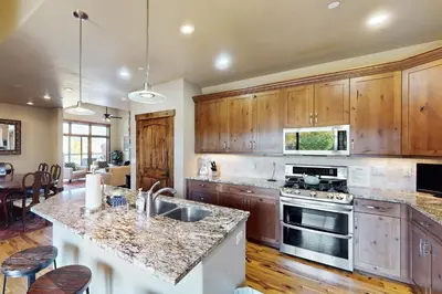 a kitchen with wooden cabinets and a counter top at Bears Den Condo Unit 1 in Frisco