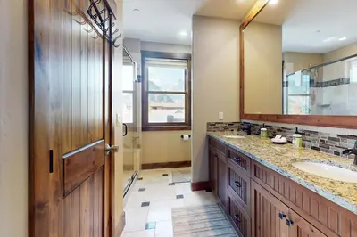 a bathroom with a sink and a mirror at Bears Den Condo Unit 1 in Frisco