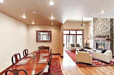a dining room with a table and a fireplace at Bears Den Condo Unit 1 in Frisco