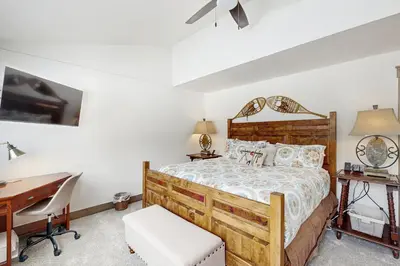 a bedroom with a wooden bed with a desk and a desk at The Pines Condo Unit 2044 in Keystone