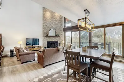 a dining room and living room with a table and chairs at The Pines Condo Unit 2044 in Keystone