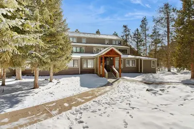 a house in the snow with its door open at The Pines Condo Unit 2044 in Keystone