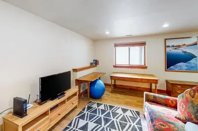 a living room with a couch and a tv at Water Dance Townhome 495 in Frisco