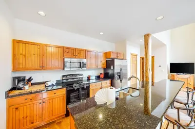 a kitchen with wooden cabinets and a counter top at Water Dance Townhome 495 in Frisco