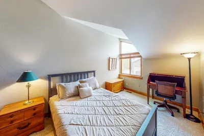a bedroom with a bed and a desk and a chair at Water Dance Townhome 495 in Frisco