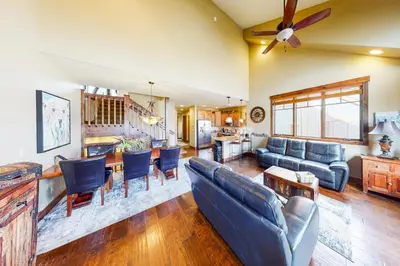 a living room with blue couches and a kitchen at Buffalo Lodge Townhomes 1293 in Silverthorne