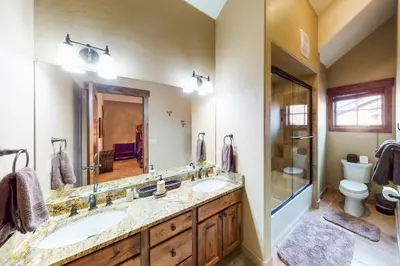 a bathroom with two sinks and a shower and a toilet at Buffalo Lodge Townhomes 1293 in Silverthorne