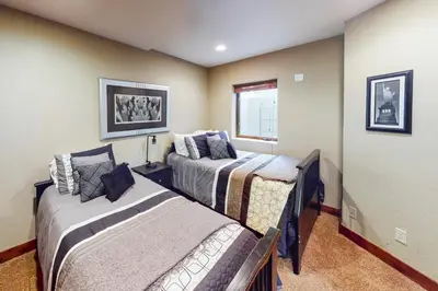 a bedroom with two beds and a window at Buffalo Lodge Townhomes 1293 in Silverthorne