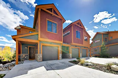 a large wooden house with a garage at Buffalo Lodge Townhomes 1293 in Silverthorne
