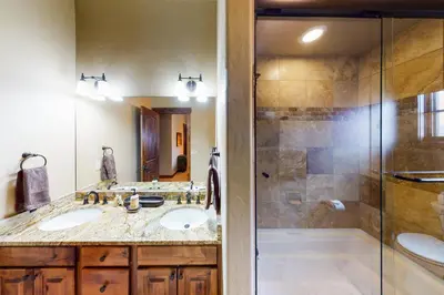 a bathroom with two sinks and a shower at Buffalo Lodge Townhomes 1293 in Silverthorne