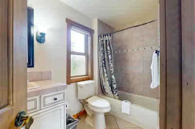 a bathroom with a toilet and a sink and a window at Ski Your Heart Out in Silverthorne