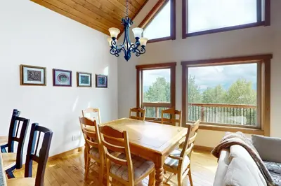 a dining room with a wooden table and chairs at Ski Your Heart Out in Silverthorne
