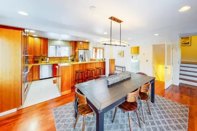 a kitchen with a wooden table and chairs at Wild Flower House in Frisco
