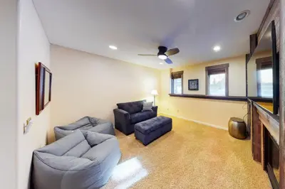 a living room with two couches and a tv at Wild Flower House in Frisco