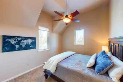a bedroom with a bed and a ceiling fan at Wild Flower House in Frisco