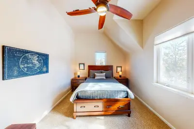 a bedroom with a bed and a ceiling fan at Wild Flower House in Frisco