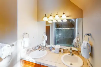 a bathroom with two sinks and a large mirror at Wild Flower House in Frisco