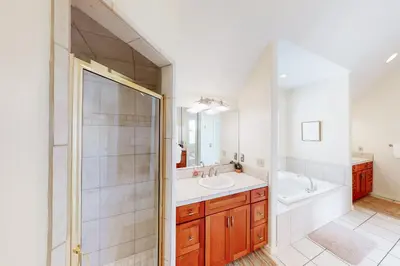 a bathroom with a tub and a sink and a shower at Wild Flower House in Frisco
