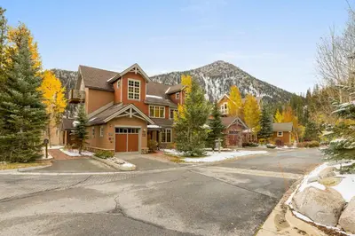 a house on a street with a mountain in the background at 6516 Settlers Creek condo in Snake River Health Services Incorporated Heliport