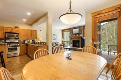 a kitchen and dining room with a wooden table and chairs at 6516 Settlers Creek condo in Snake River Health Services Incorporated Heliport