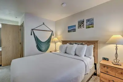 a bedroom with a bed and a hammock on the wall at Condo with Views and Hot Tub Access in Silverthorne! in Silverthorne