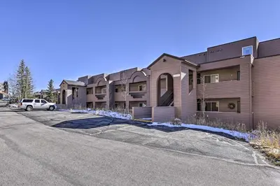 an apartment building with a car parked in front of it at Condo with Views and Hot Tub Access in Silverthorne! in Silverthorne