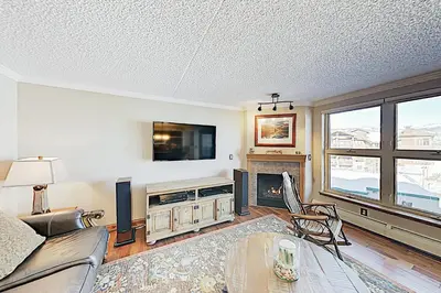 a living room with a couch and a tv at The Towers Unit 407 in Frisco