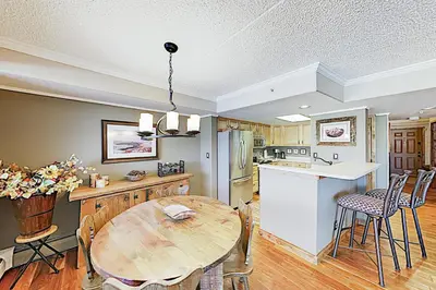 a kitchen and dining room with a wooden table at The Towers Unit 407 in Frisco