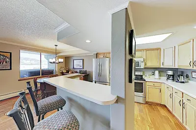 a kitchen with a counter and some chairs in it at The Towers Unit 407 in Frisco