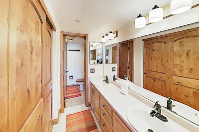 a bathroom with two sinks and a large mirror at The Towers Unit 407 in Frisco