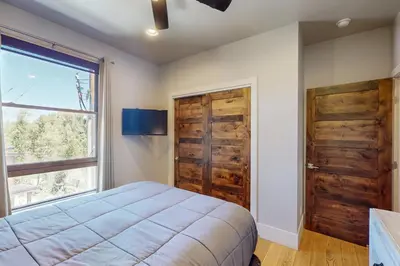 a bedroom with a bed and a window and a door at Blue River Condo Unit 3301 in Silverthorne