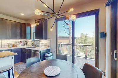 a kitchen with a table and a large window at Blue River Condo Unit 3301 in Silverthorne