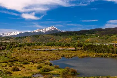a view of a mountain with a lake and trees at Blue River Condo Unit 3301 in Silverthorne