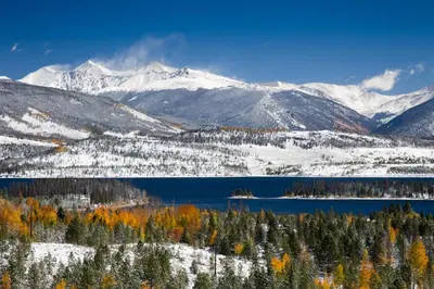 a view of a snowy mountain range with a lake at Blue River Condo Unit 3301 in Silverthorne