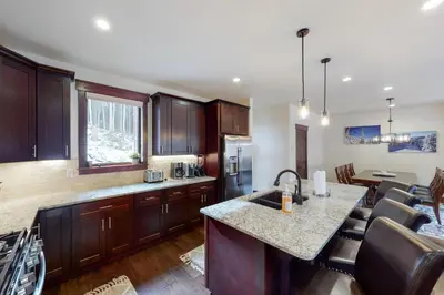 a kitchen with wooden cabinets and a counter top at New Keystone Resort Home in Keystone