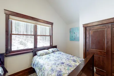 a bedroom with a bed and a window at New Keystone Resort Home in Keystone