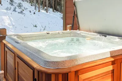 a jacuzzi tub with snow on the ground at New Keystone Resort Home in Keystone
