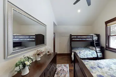 a bedroom with two bunk beds and a mirror at New Keystone Resort Home in Keystone