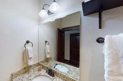 a bathroom with a sink and a large mirror at New Keystone Resort Home in Keystone