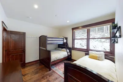 a bedroom with two bunk beds and a window at New Keystone Resort Home in Keystone