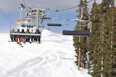a group of people on a ski lift in the snow at Watch Hill Condos Unit 614 in Silverthorne