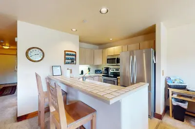 a kitchen with a counter and a refrigerator at Watch Hill Condos Unit 614 in Silverthorne