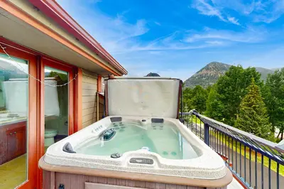 a jacuzzi tub on the balcony of a house at Marine Park Condo Unit C-16 in Frisco