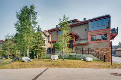 a house with three sheep laying in front of it at Marine Park Condo Unit C-16 in Frisco