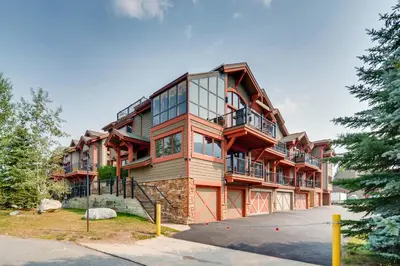 a large apartment building with glass windows at Marine Park Condo Unit C-16 in Frisco