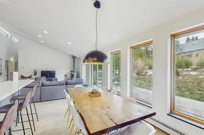 a dining room and living room with a table and chairs at Mountain Modern Escape in Fraser