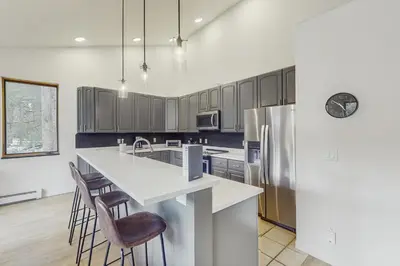 a kitchen with a white counter and a refrigerator at Mountain Modern Escape in Fraser