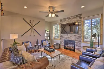 a living room with a couch and a fireplace at 6 Mi to Keystone Ski! Mtn-View Cabin with Game Room in Silverthorne